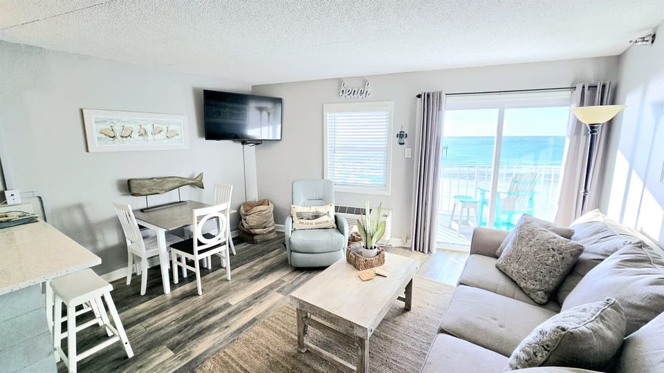 Dining area and living room with Gulf-front windows