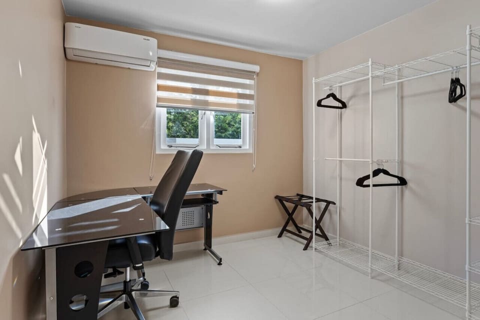 Private workspace located in the walk-in closet of the master bedroom, offering a quiet and secluded area with a closable door for maximum privacy.
