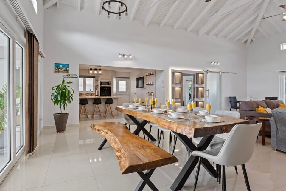 The dining table is located next to the living room in the open-concept heart of the house, adjacent to the kitchen.