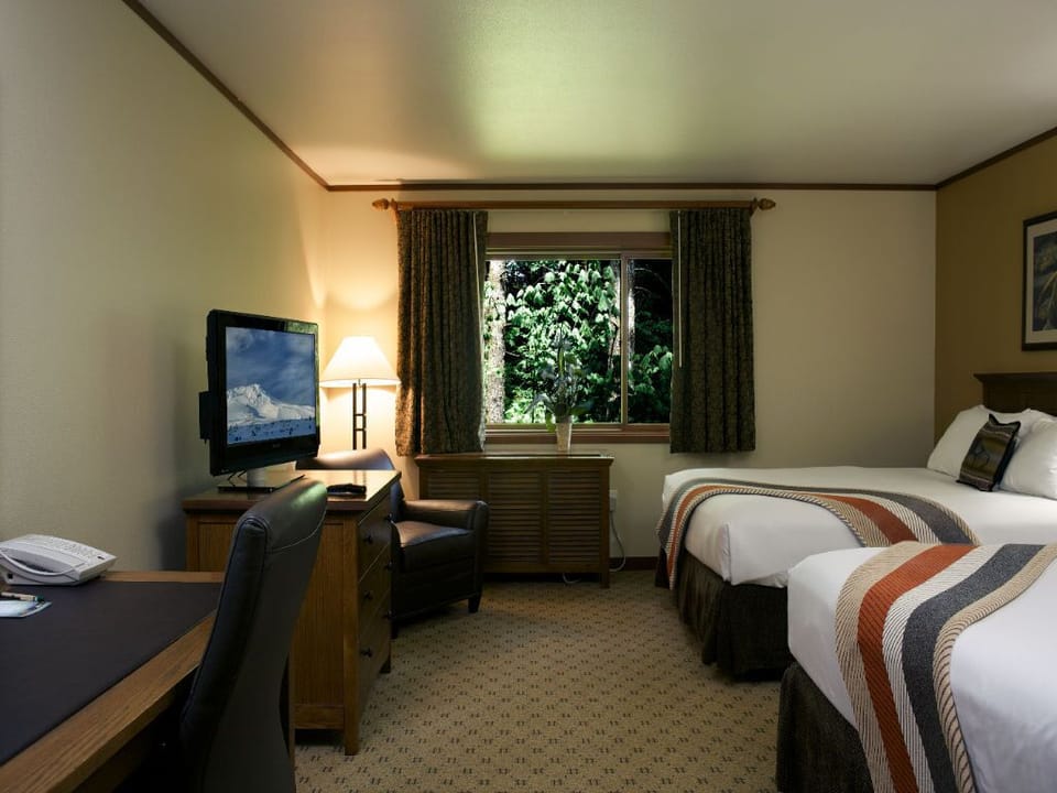 A bright and cozy room featuring a welcoming workspace and tranquil views of the greenery outside.