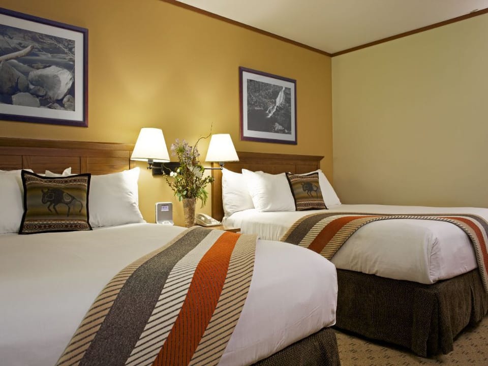 A serene retreat with inviting beds and soft, warm accents, perfect for relaxation.