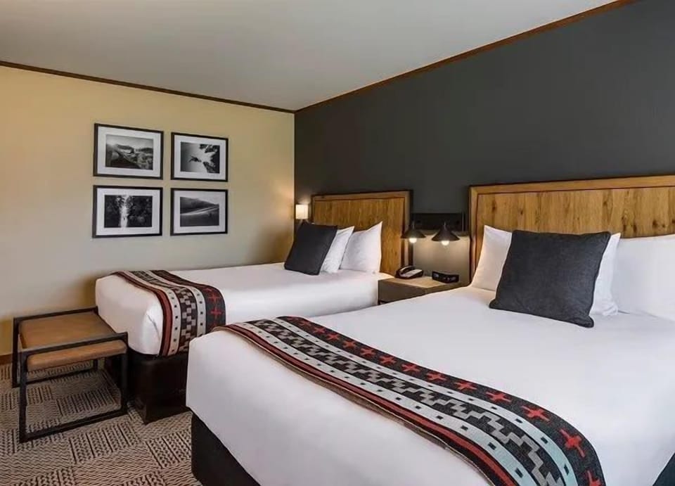 A serene retreat featuring plush beds and soft lighting, perfect for a restful night’s sleep after a day of exploring.
