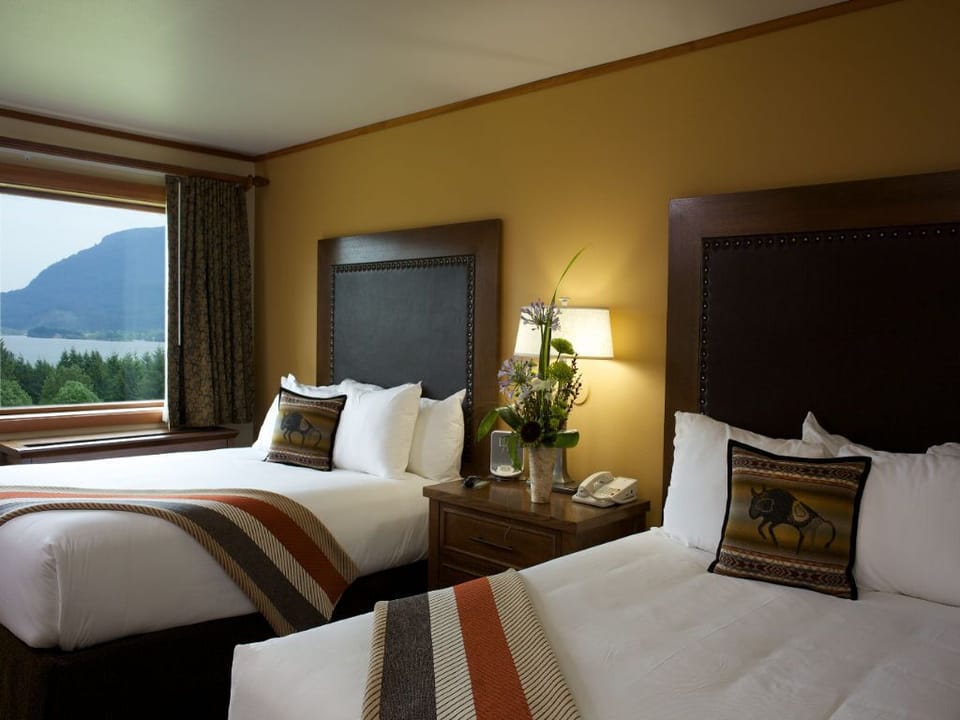 A serene bedroom with inviting beds and a calming view, creating a restful escape.