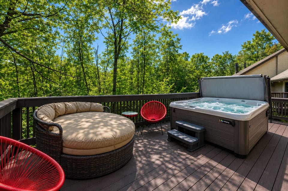 Sunny private patio retreat with saltwater hot tub, lounge seating, and wooded summer views