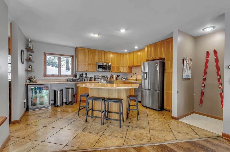 Fully equipped kitchen with island seating, stainless appliances, and open entertaining layout