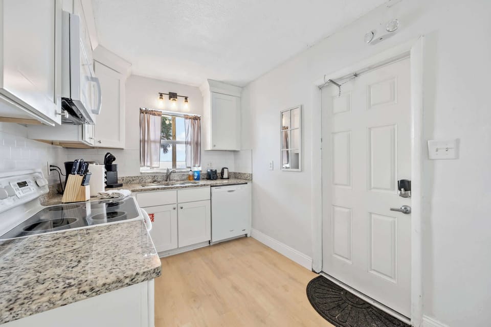 Bright kitchen with granite countertops and modern appliances