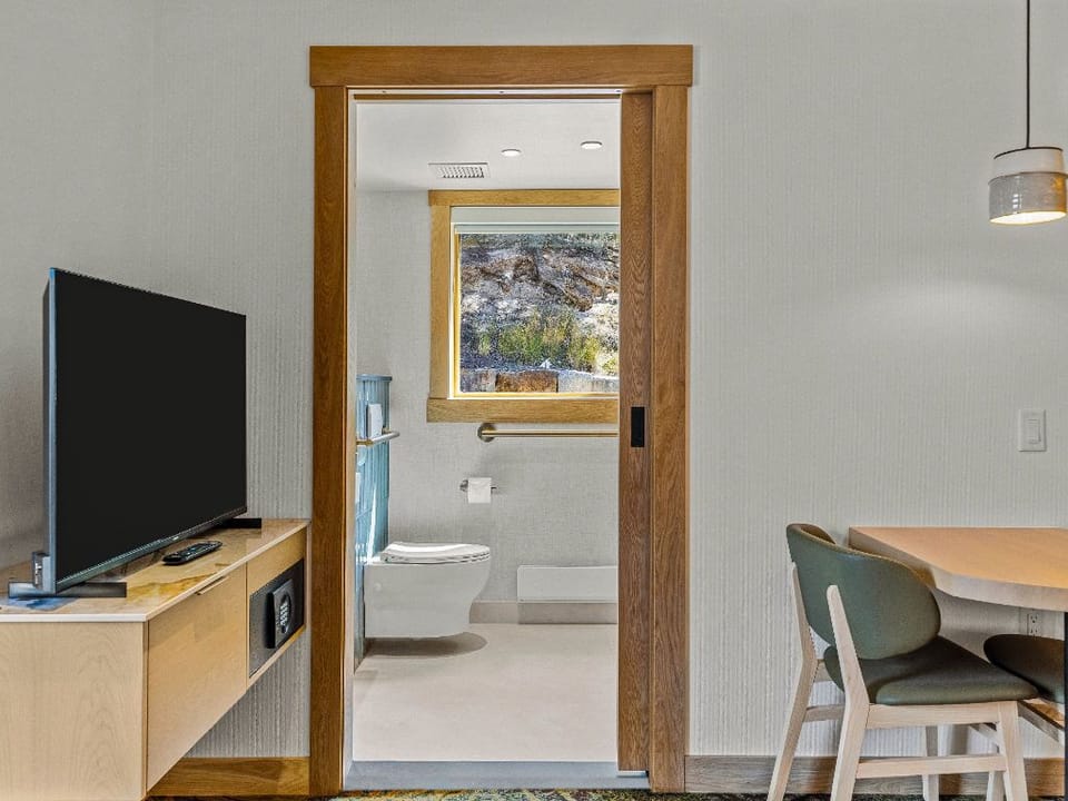 A cozy corner with a small dining table and a TV, perfect for enjoying meals or unwinding with your favorite shows after a day of adventure.