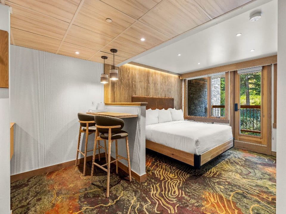 A stylish and open space with a dining area and easy access to a serene outdoor view, perfect for leisurely mornings.