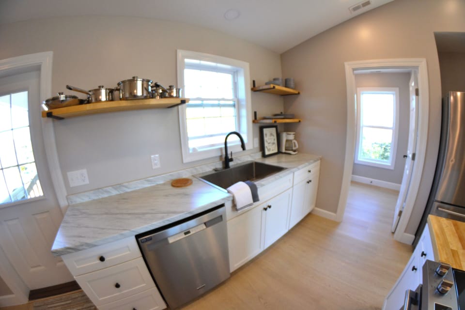 Beautiful butcher block shelves for easy everyday access and extra large sink