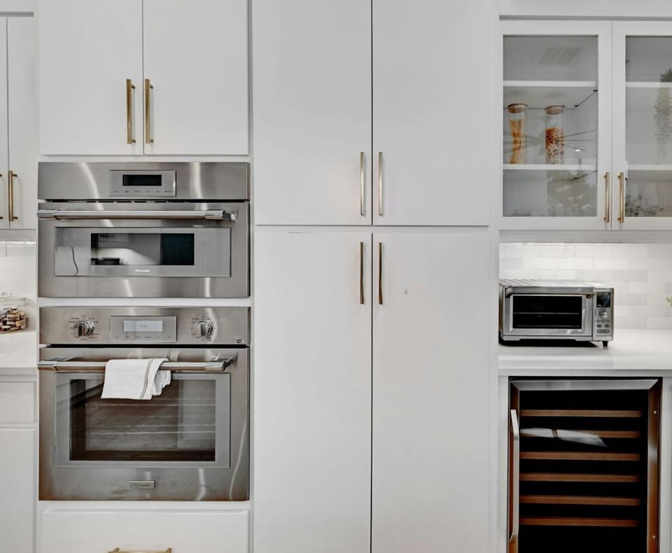 Ready to whip up something delicious? This kitchen corner’s got it all—modern appliances, sleek storage, and even a wine fridge for when cooking gets serious.