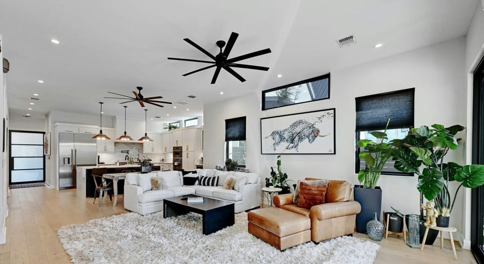 This living room invites you to relax and recharge, with plush sofas, and cozy throw pillows.