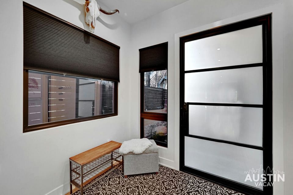 Step right in! This stylish entryway sets the tone—modern, cozy, and a little bit Texan (yes, that’s a longhorn on the wall). Your Austin stay starts here!