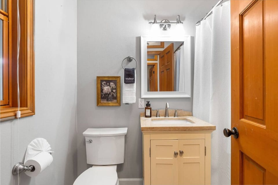 Full bathroom with shower, located across the hall from the 1st floor bedroom.