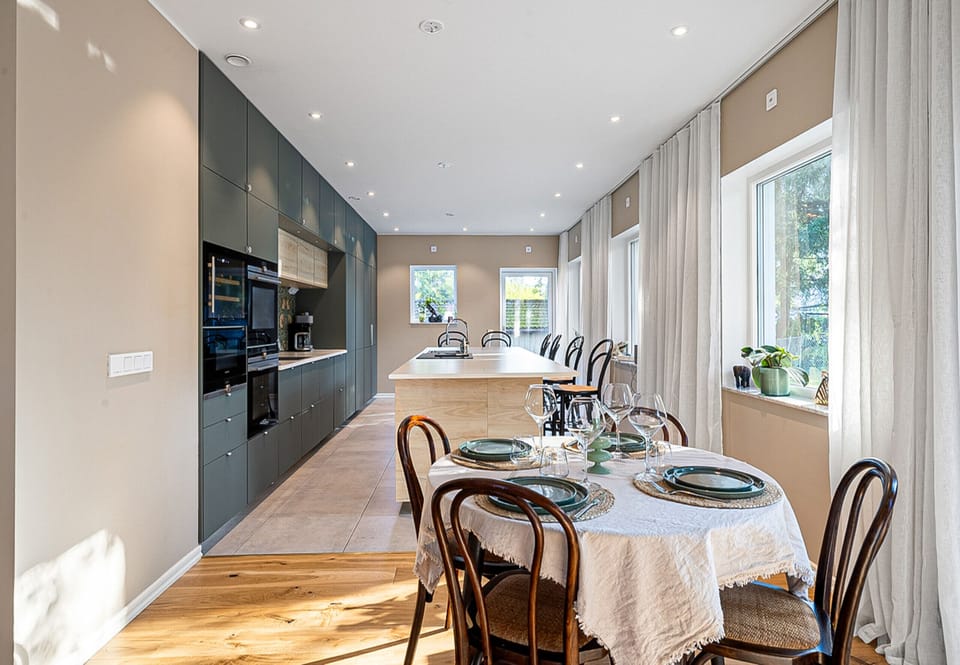 A smaller dining table and a long bar counter with room for more
