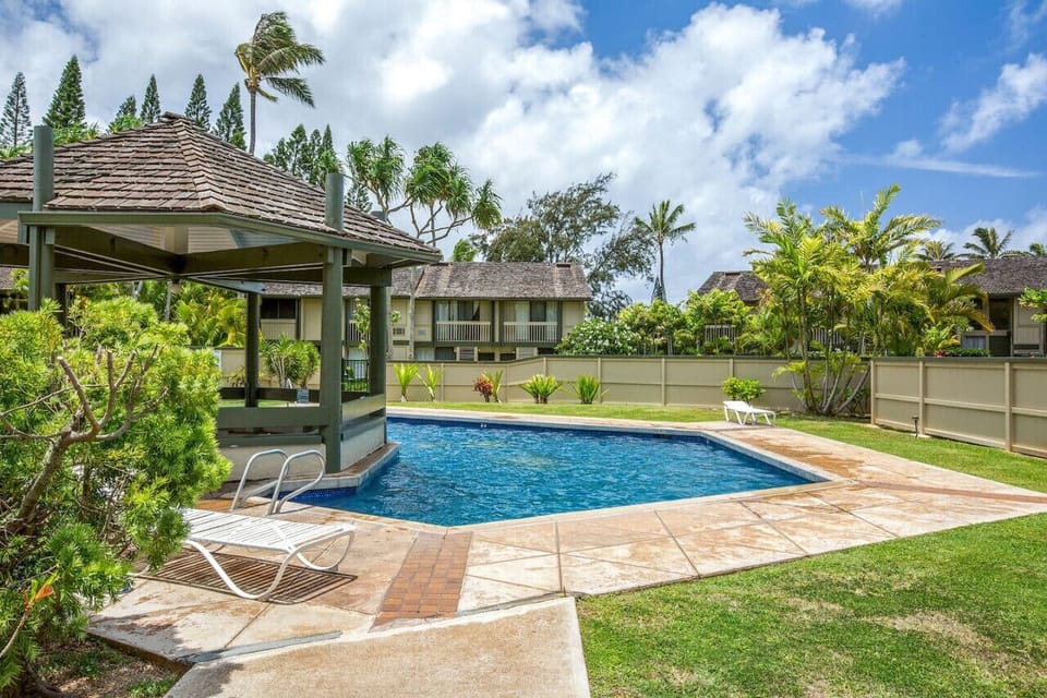 Sparkling pool beside lush gardens perfect for slow afternoons.