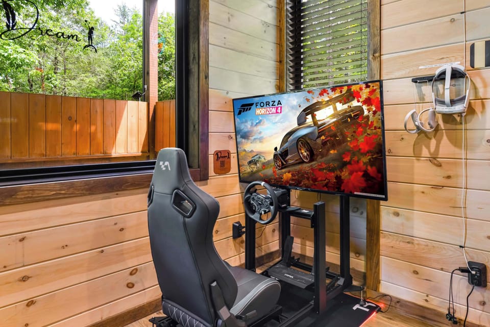 Modern gaming setup with racing simulator and virtual reality headset in a wood-paneled room.