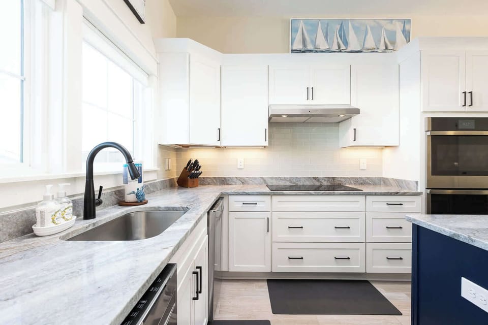 Modern fully-equipped kitchen with a large island and bar seating (seats 3) for casual dining (w/ stove, oven, microwave, toaster, Keurig, and more)
