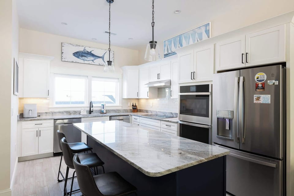 Modern fully-equipped kitchen with a large island and bar seating (seats 3) for casual dining (w/ stove, oven, microwave, toaster, Keurig, and more)