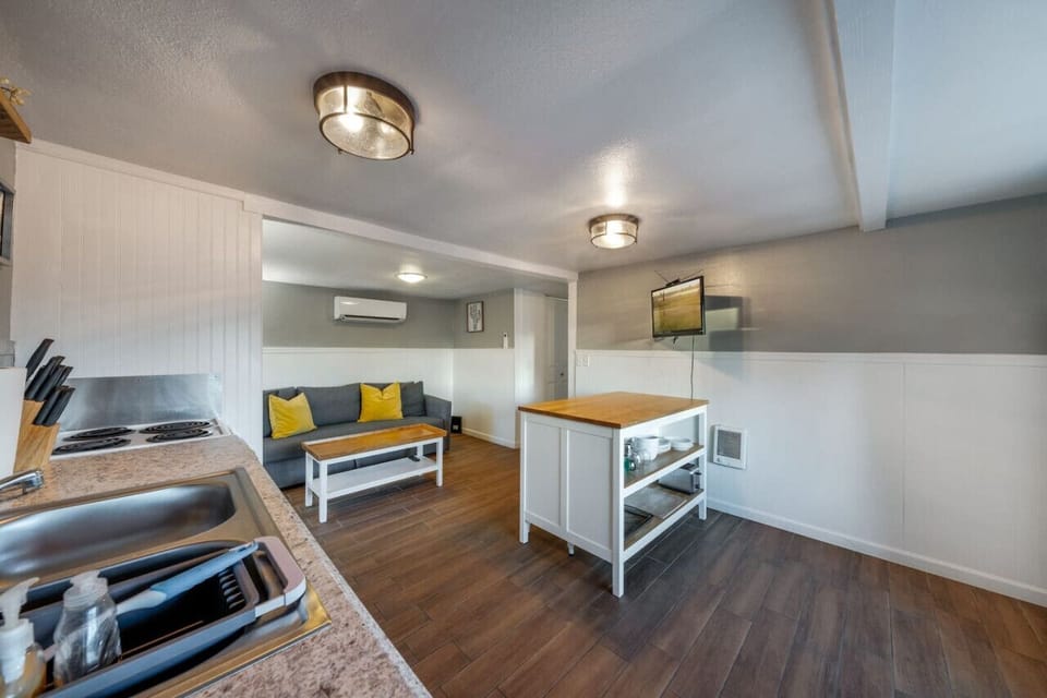 HOUSE: Well-equipped kitchen with island and living room area with sofa bed
