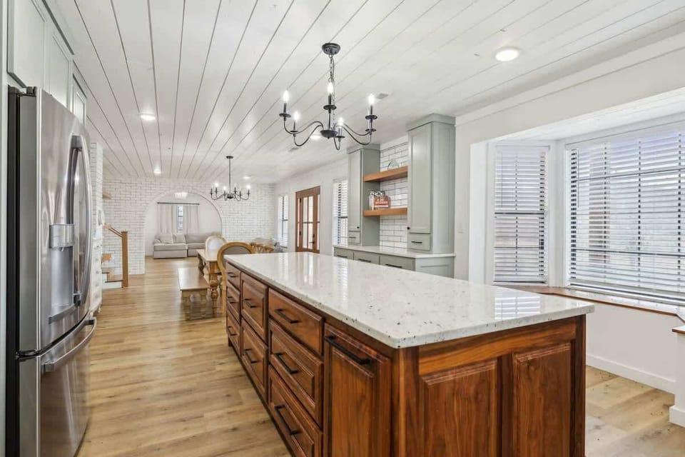 Fully equipped kitchen featuring stainless steel appliances and a kitchen island offering plenty of counter space.