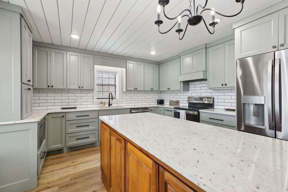 Fully equipped kitchen featuring stainless steel appliances and a kitchen island offering plenty of counter space.