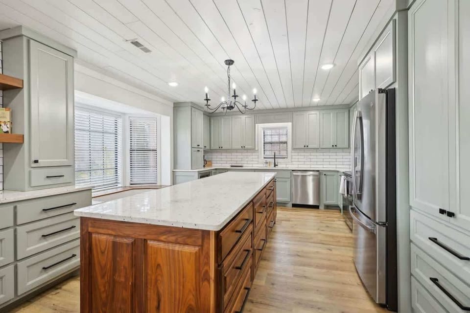 Fully equipped kitchen featuring stainless steel appliances and a kitchen island offering plenty of counter space.