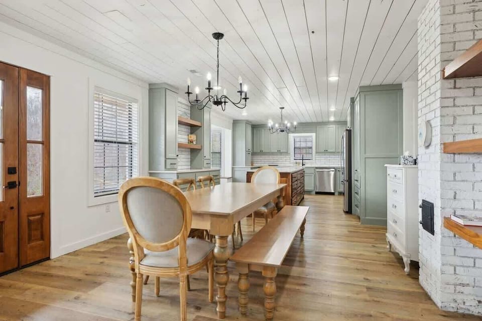 Large dining area next to the kitchen with seating for 8 guests. Fully equipped modern kitchen stocked with all culinary essentials and featuring brand new stainless steel appliances with an island offering bar seating.