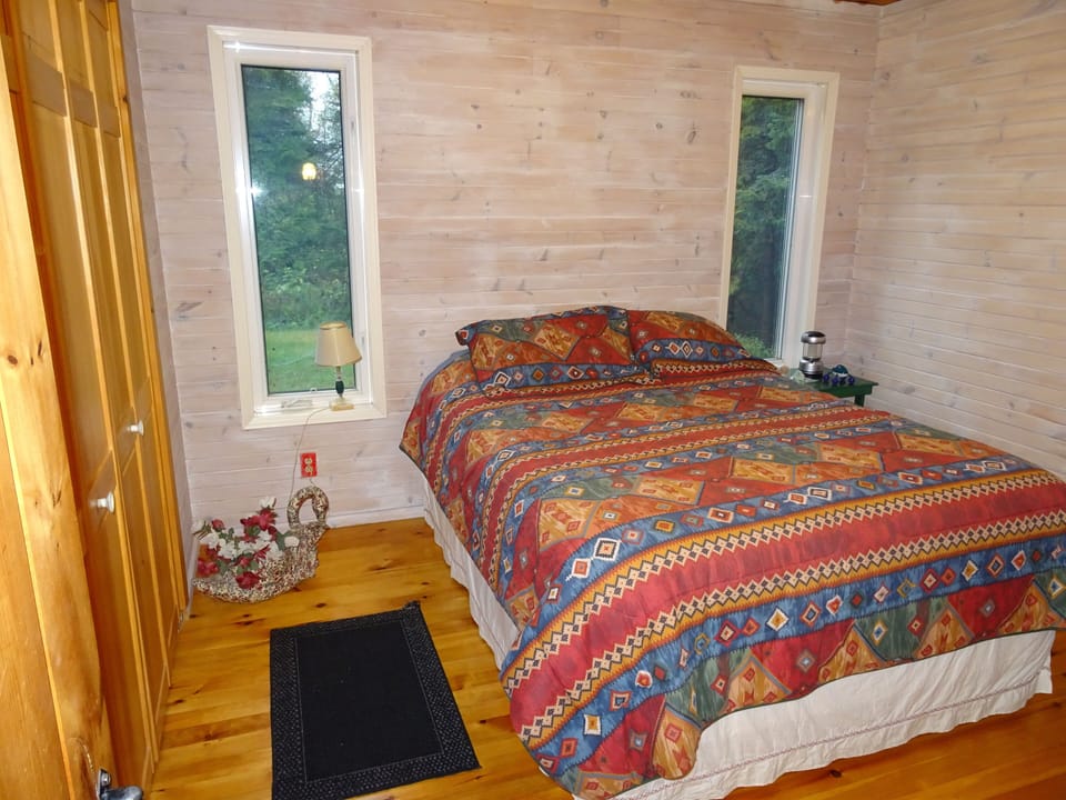 Master bedroom with queen bed on top floor of cottage. Same floor as kitchen.