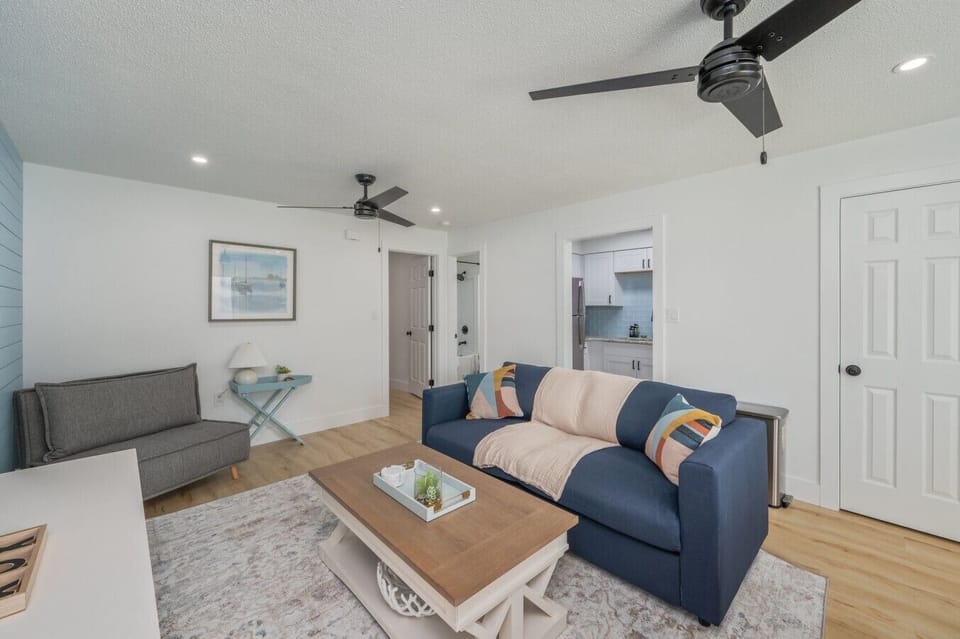 Stylish blue sofa and decor create a relaxing, inviting vibe.