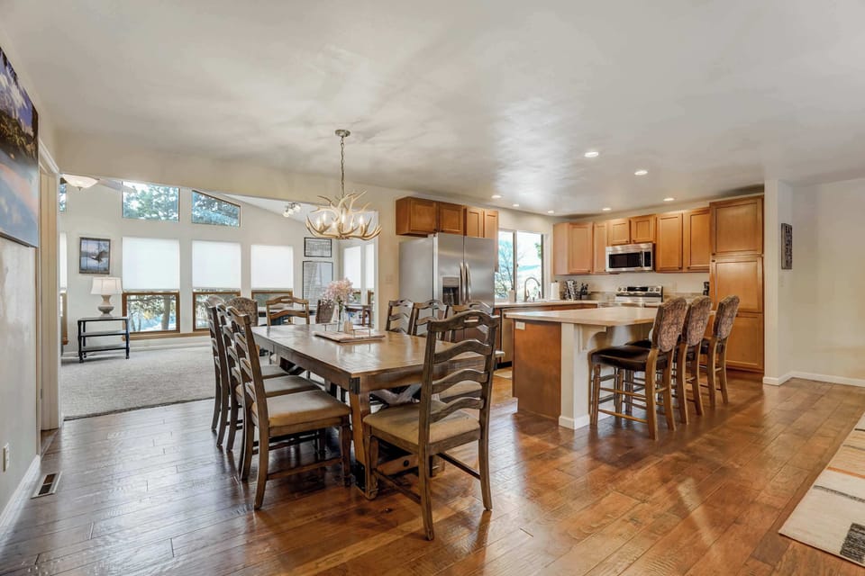 Gather in the open-concept living space with cozy seating, a large Smart TV, and a spacious dining area perfect for entertaining!