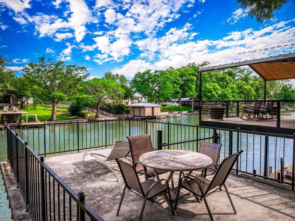 Private riverside patio with outdoor seating and peaceful waterfront views perfect for morning coffee or sunset chats.
