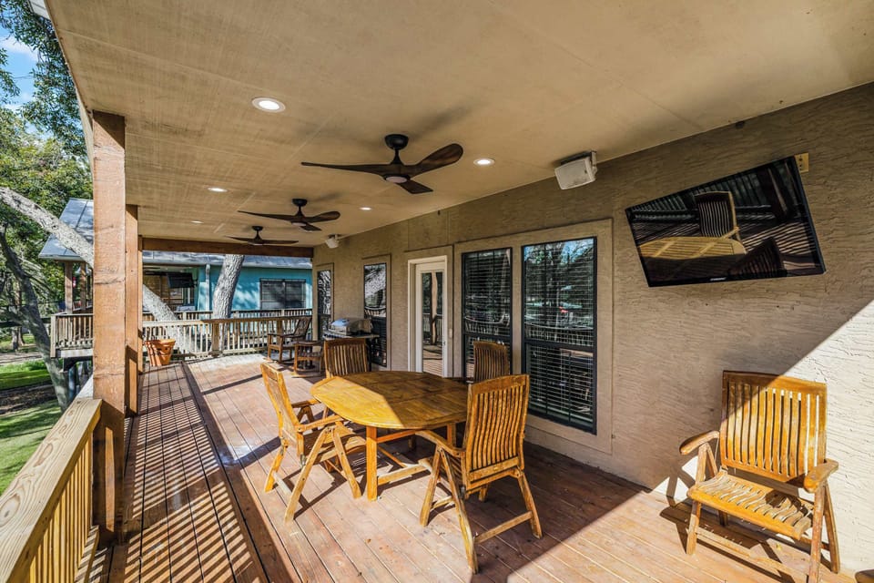 Enjoy the outdoors in comfort — spacious deck with a TV and cozy seats.
