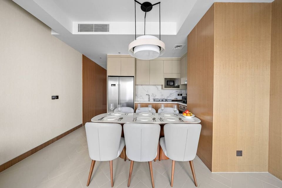 Modern elegance: chic dining table under a stylish light fixture.