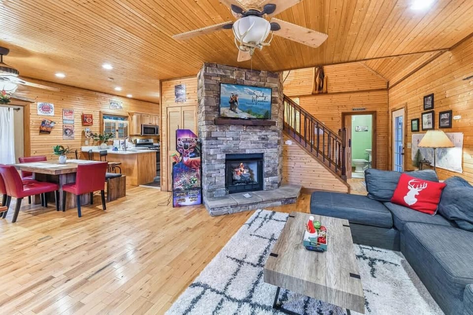 Cozy living area with a stone fireplace and rustic wood interiors.