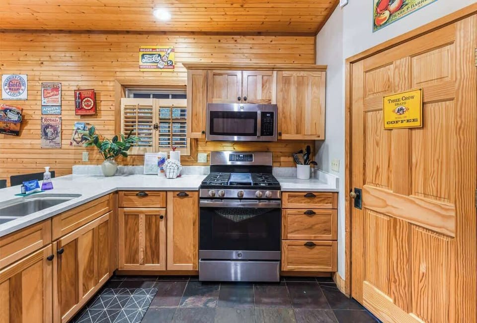 rustic kitchen with stainless steel appliances and wood cabinetry