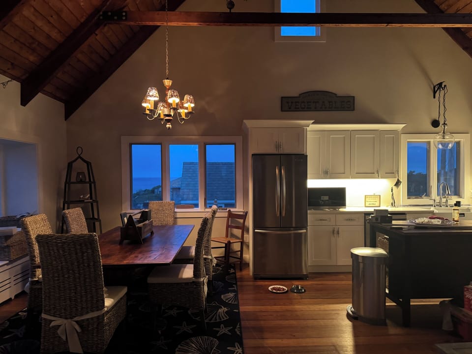 Evening view of dining room and kitchen
