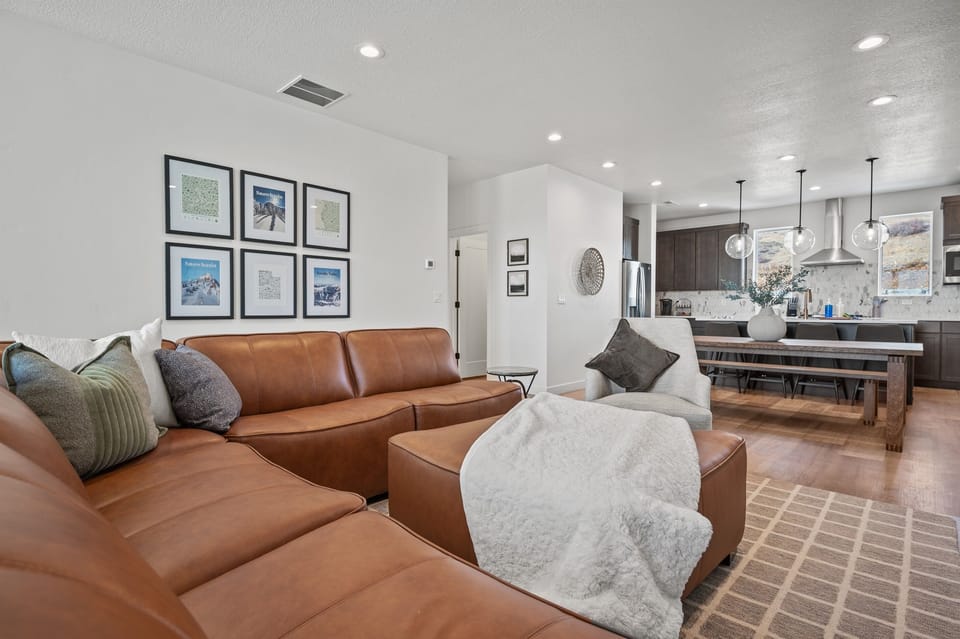 The open-concept living space, complete with a dining area, facilitates effortless conversation with family and friends.