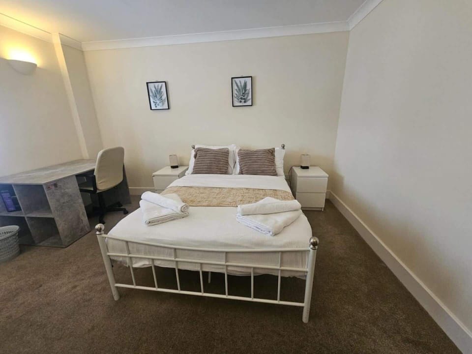 Designed for modern travellers, this bedroom features a dedicated workspace, providing a comfortable environment for both business and leisure stays