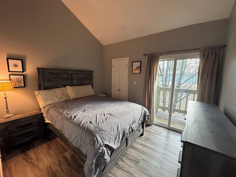 Master with nightstands including charger/usb plugs and balcony