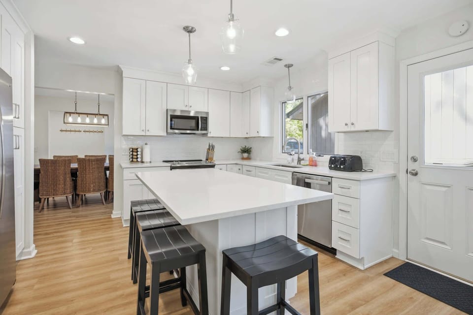 Modern kitchen with a large island and seating for four.