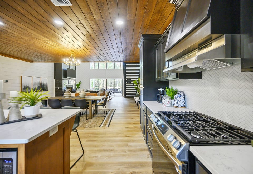 The open kitchen flows beautifully into the living space, creating an airy layout that’s perfect for gatherings and everyday moments.