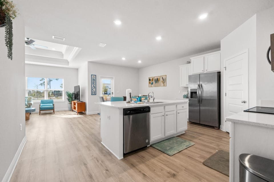 Step into your bright, modern kitchen with sleek appliances and open layout flowing to the cozy living space—perfect for relaxing.