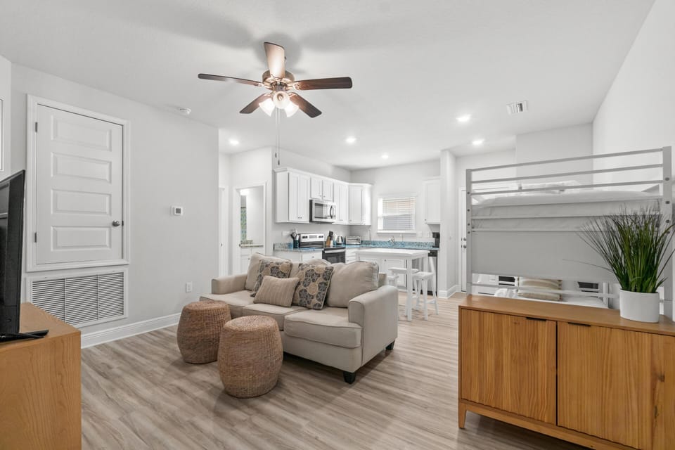 Relax in your bright, modern living space with comfortable seating and an open kitchen perfect for preparing meals together.