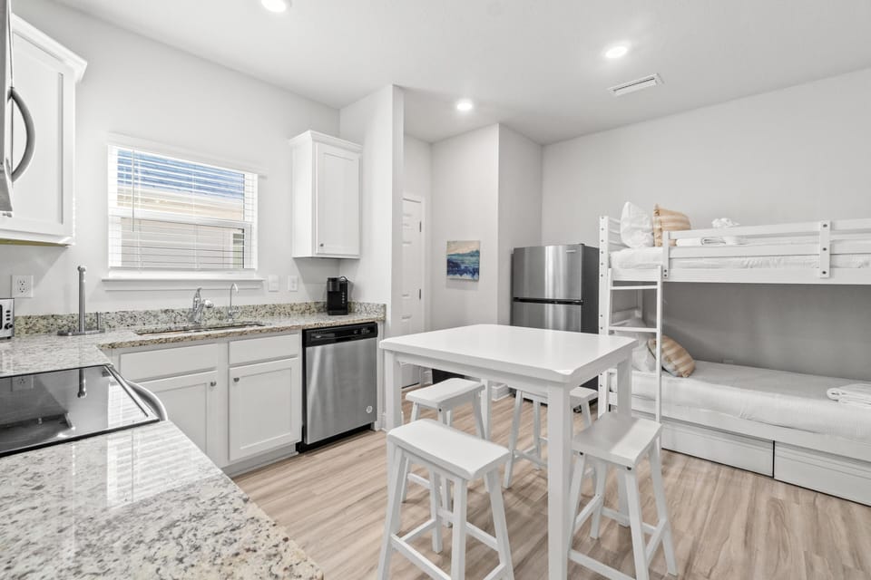 Your modern kitchen features granite counters, stainless appliances, and a cozy dining island, while twin bunks maximize space for your group.