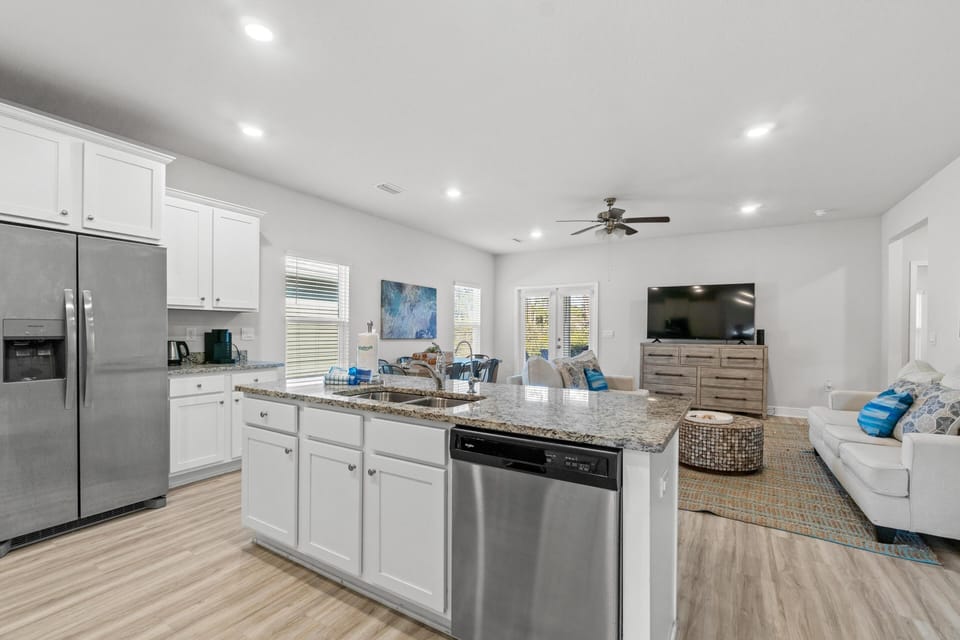Your open-concept kitchen and living space features granite countertops, stainless appliances, and comfortable seating for cooking and relaxing together.