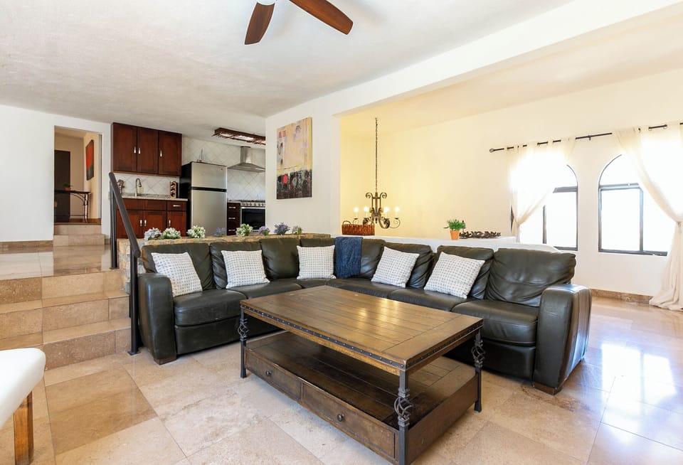 The living room is spacious and seamlessly opens to the kitchen area, creating a welcoming and connected space for relaxation and entertaining.