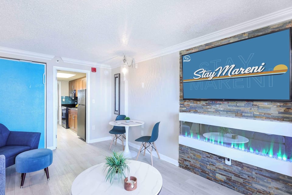 Modern comfort meets coastal charm in this inviting living space, featuring a smart TV, cozy fireplace, and a stylish dining nook. The perfect spot to relax after a beach day or enjoy a quiet night in with your favorite shows.