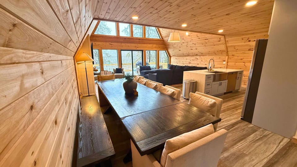 Open-concept living space with vaulted ceilings, natural wood interiors, and plenty of room to relax, dine, and gather.