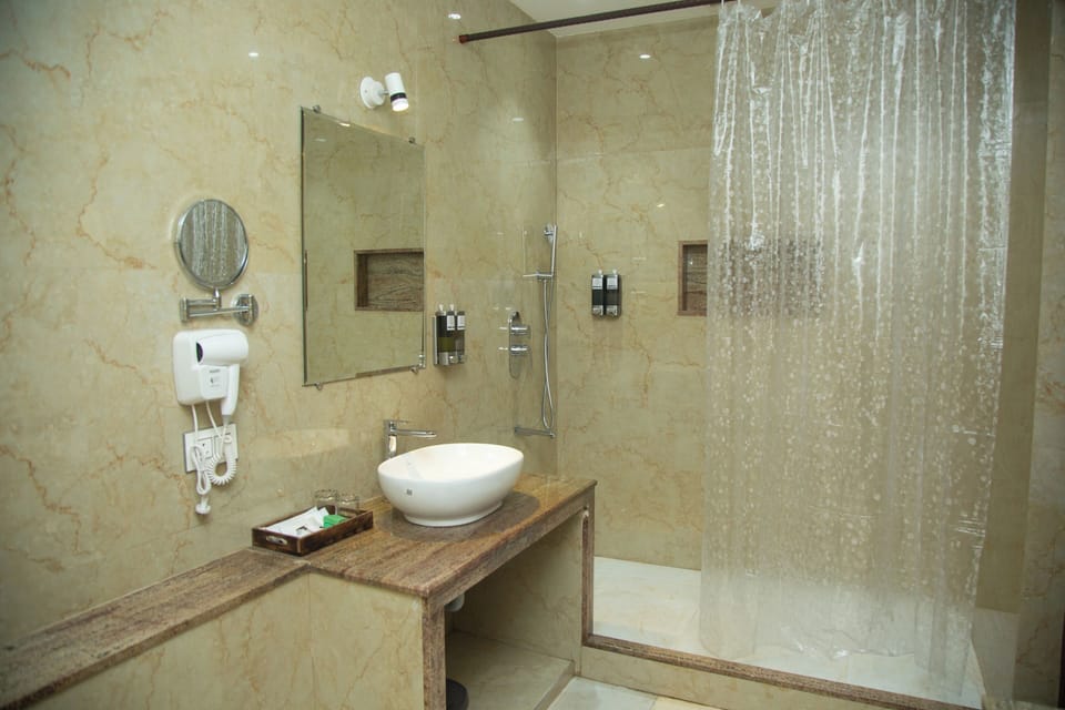 Shower, hair dryer, slippers, towels