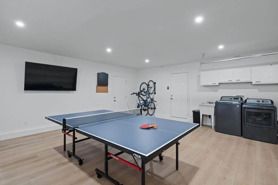 Game room with ping pong, games, and two bikes